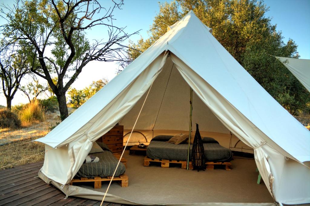 a white tent with two beds in it at Shauri Glamping in Noto