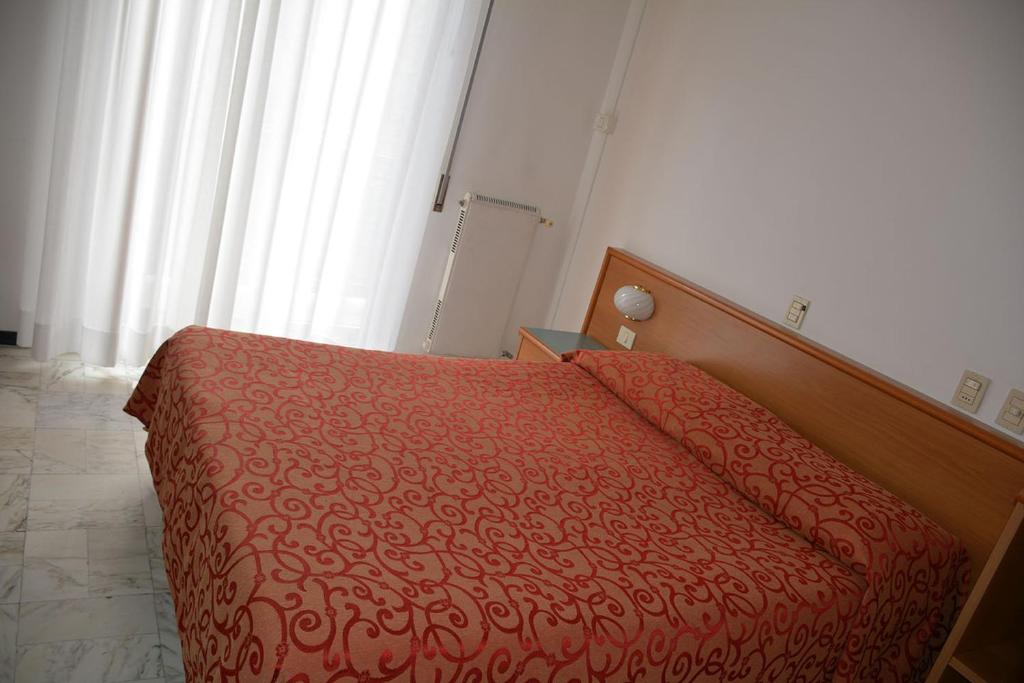 Postel nebo postele na pokoji v ubytování Hotel Valentino