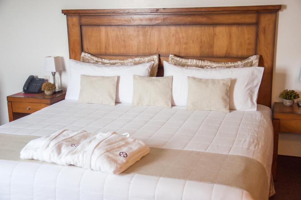 Postel nebo postele na pokoji v ubytování De la Trinidad Hotel