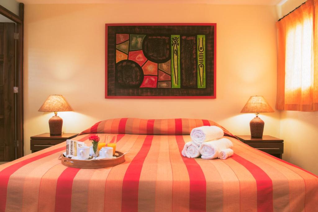 Postel nebo postele na pokoji v ubytování Hotel Las Palmeras