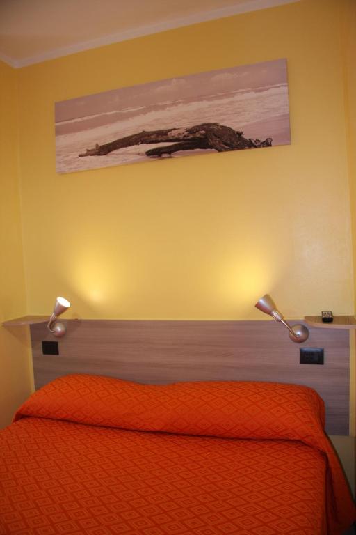 Postel nebo postele na pokoji v ubytování Hotel Adelchi