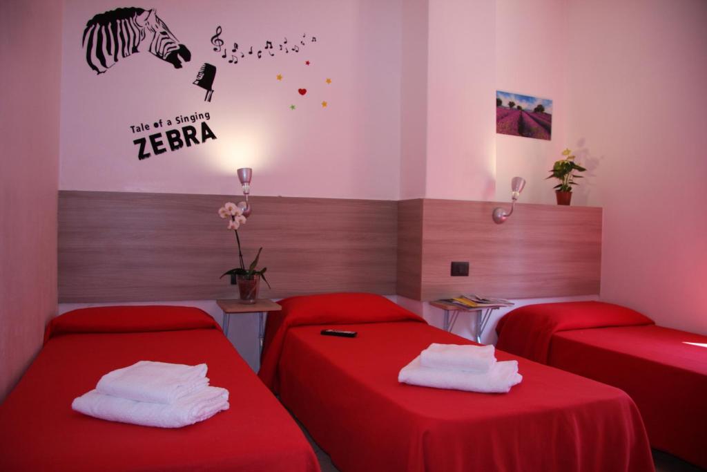 Postel nebo postele na pokoji v ubytování Hotel Adelchi