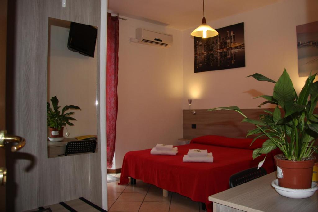 Postel nebo postele na pokoji v ubytování Hotel Adelchi