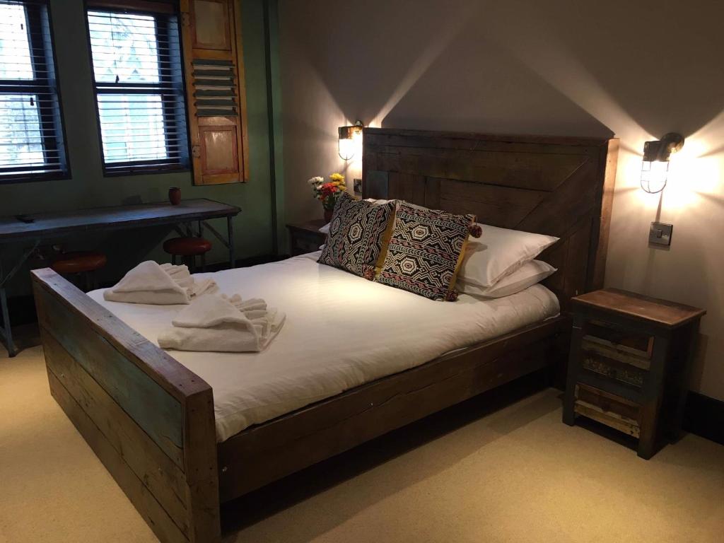 a bedroom with a bed with white sheets and pillows at Charter House in Newport