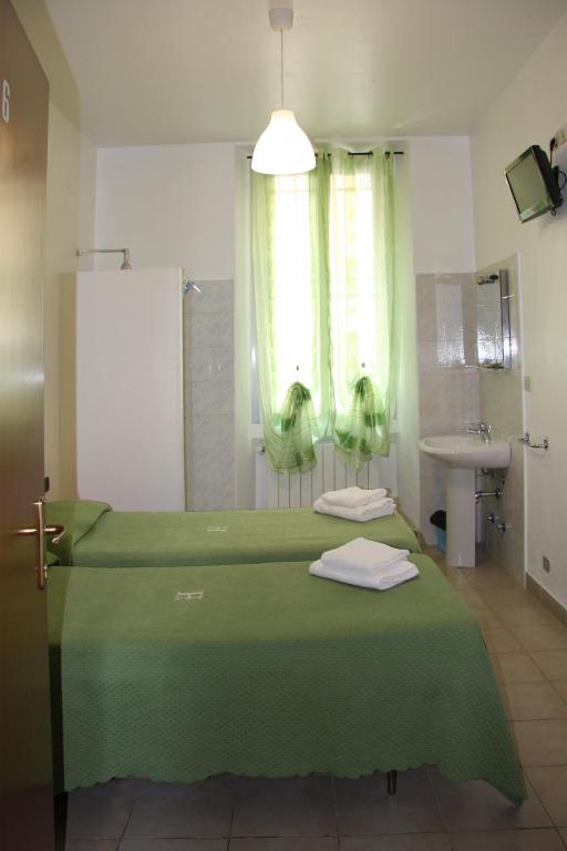 Postel nebo postele na pokoji v ubytování Hotel Adelchi