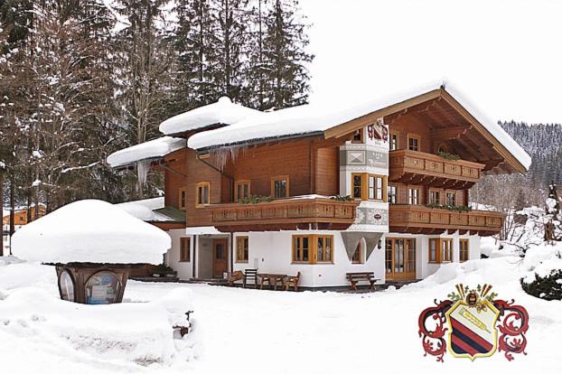 a large wooden house with snow on it at Haus am Mühlenweg in Altenmarkt im Pongau