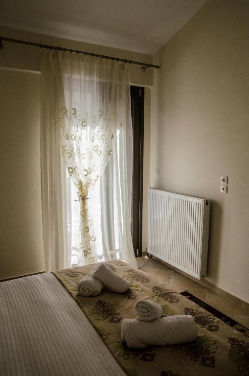 Postel nebo postele na pokoji v ubytování Pasithei