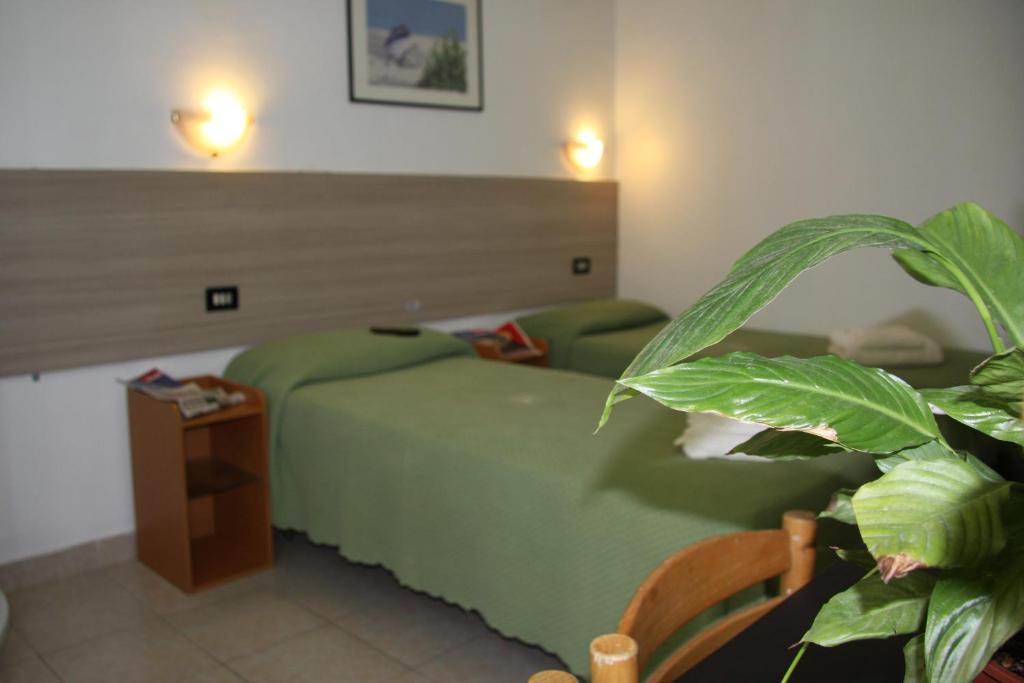 Postel nebo postele na pokoji v ubytování Hotel Adelchi