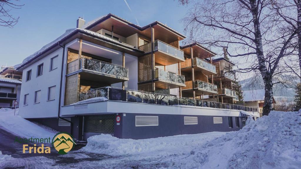 a building with snow in front of it at Apartment Frida by Da Alois in Gröbming