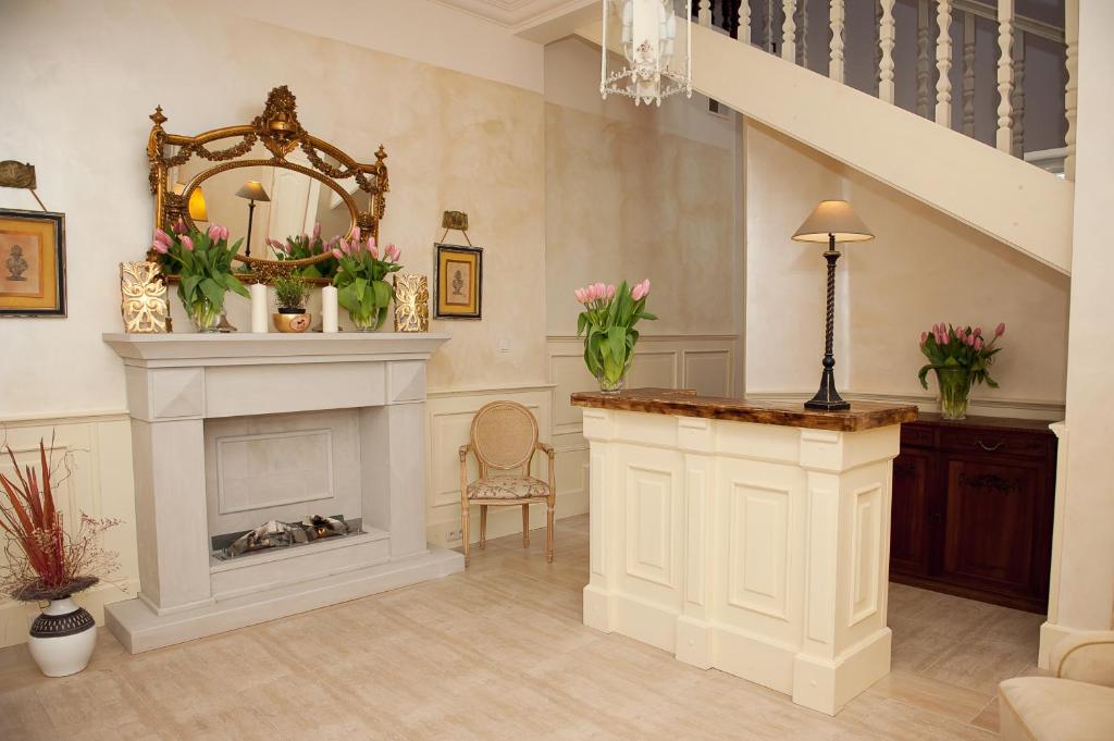 a living room with a fireplace and a staircase at Hotel&Restauracja Złote Runo in Góra Kalwaria