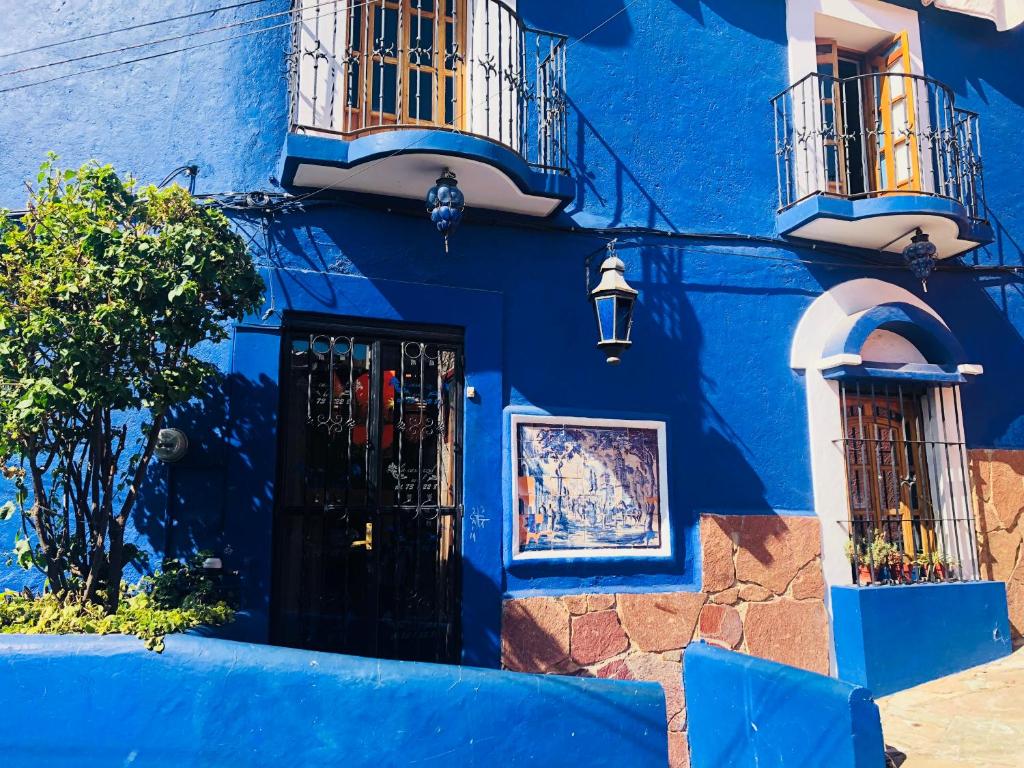 a blue building with balconies and a door at Casa Azul in Guanajuato
