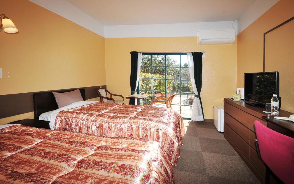 Postel nebo postele na pokoji v ubytování Kashikojima Hotel Bay Garden