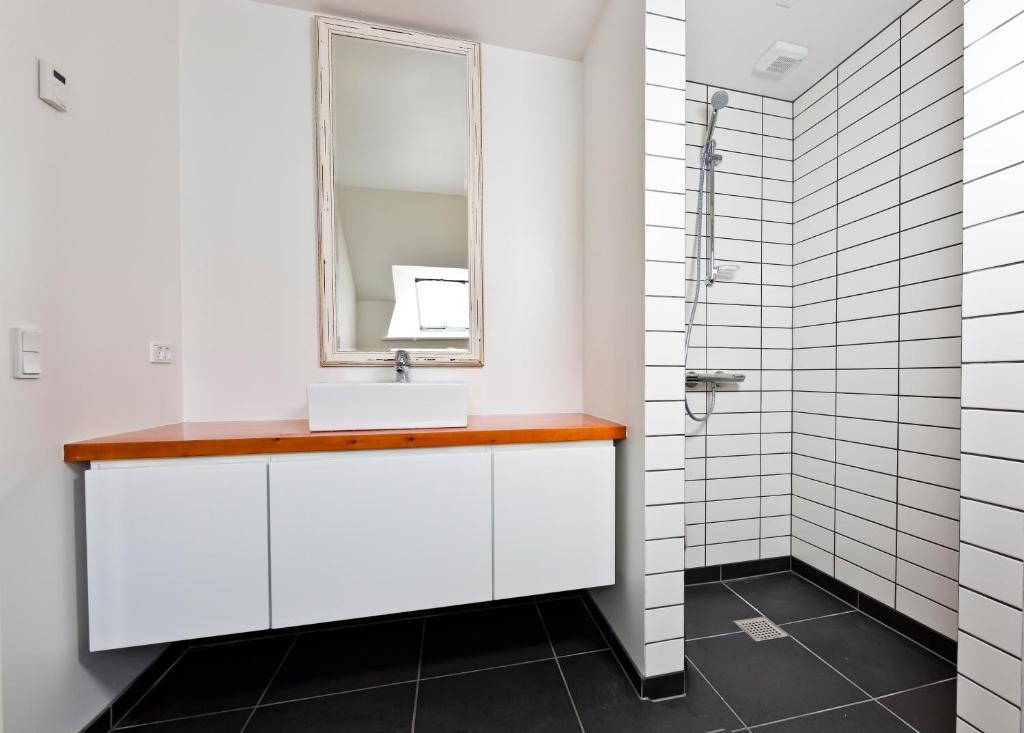 
a bathroom with a sink and a mirror at Aroma Guesthouse in Ærøskøbing
