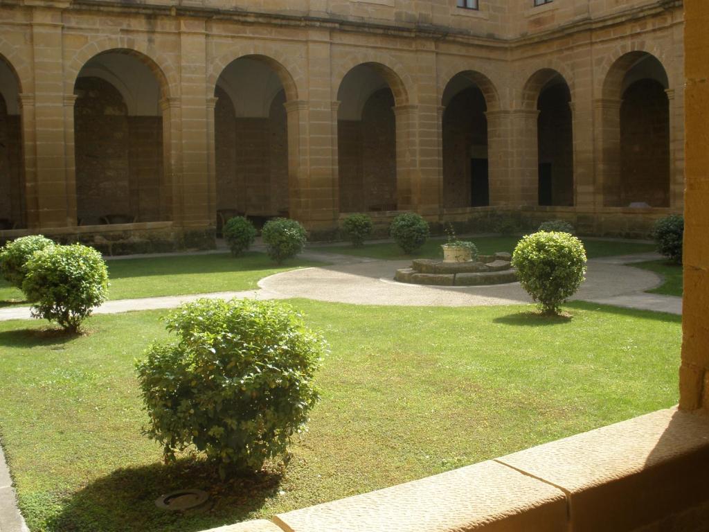 a courtyard with three trees and a building at Parador de Sto. Domingo Bernardo de Fresneda in Santo Domingo de la Calzada