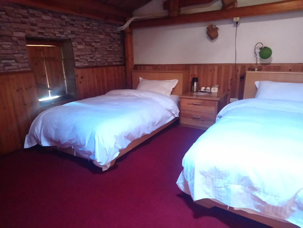 Postel nebo postele na pokoji v ubytování Jinsha Old Street B&B