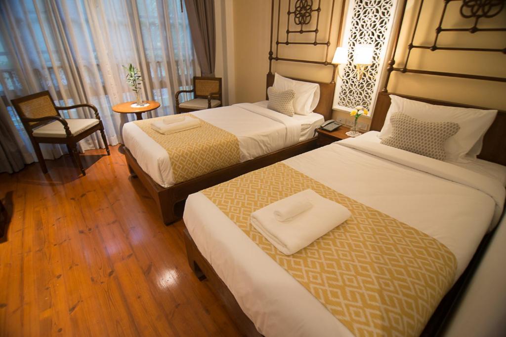 Postel nebo postele na pokoji v ubytování WOO Gallery & Boutique hotel