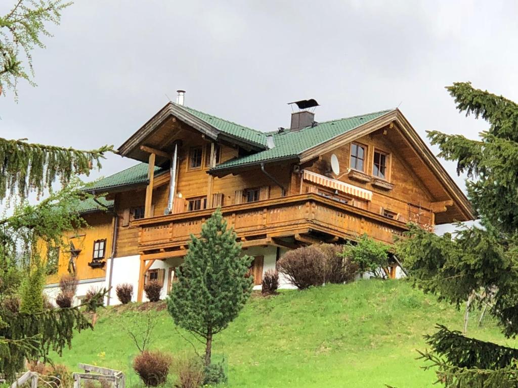 une grande maison en bois au sommet d'une colline dans l'établissement Chalet Heidi, à Bad Kleinkirchheim
