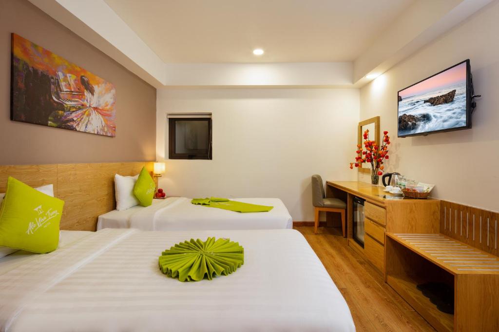 Giường trong phòng chung tại Ale Nha Trang Hotel
