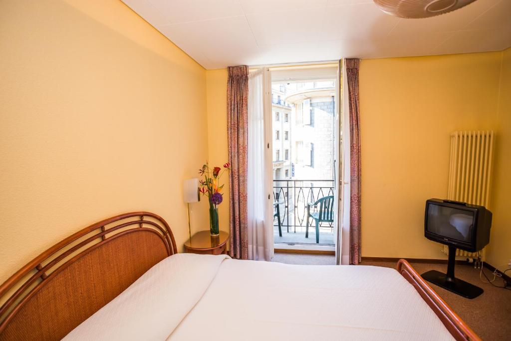 Postel nebo postele na pokoji v ubytování Hôtel Résidence Cité-Verdaine