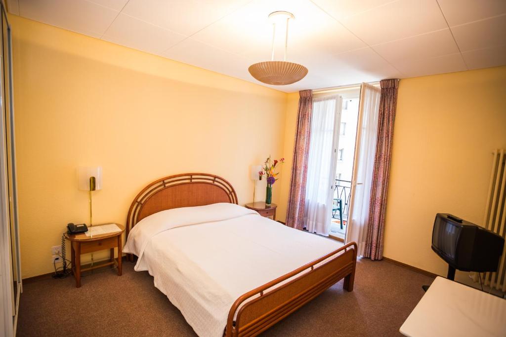 Postel nebo postele na pokoji v ubytování Hôtel Résidence Cité-Verdaine