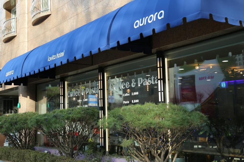 a store with a blue awning in front of a building at Lavita hotel in Seoul