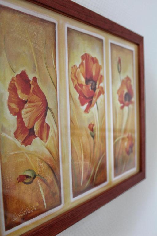 a painting of flowers is hanging on a wall at Akazienhof Hotel & Brauhaus in Cologne