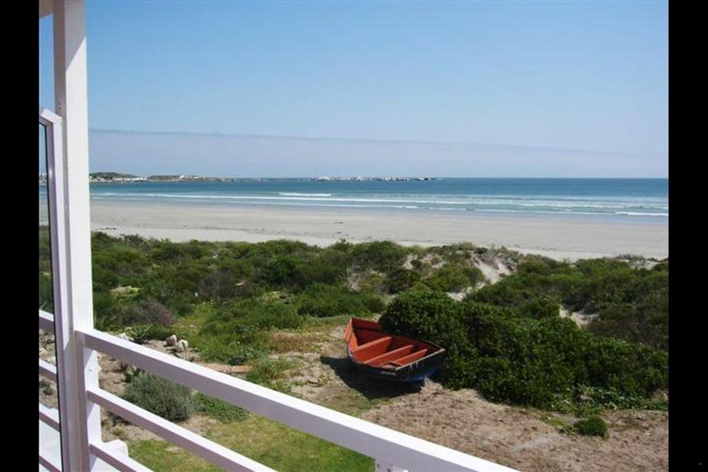 a boat sitting on the beach next to a beach at Villa Amore in Paternoster