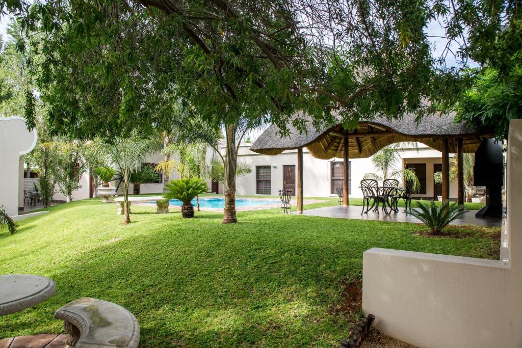 un cortile con piscina e gazebo di Schroderhuis Guesthouse NO LOADSHEDDING GOOD WIFI a Upington