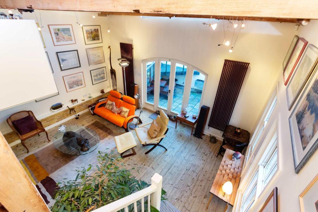 an overhead view of a living room with an orange couch at Veeve - Stables Mews in London