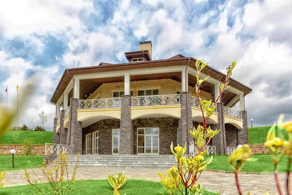 a large house with a balcony on top of it at Клубный отель "Завидово" in Zavidovo