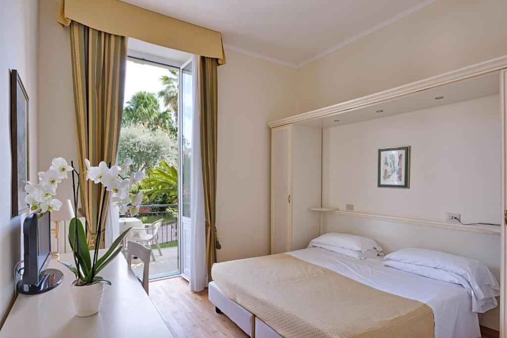 Postel nebo postele na pokoji v ubytování Hotel Paradiso