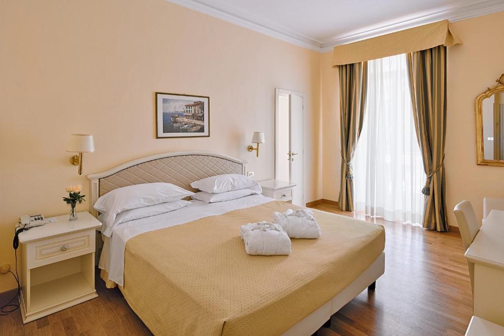 Postel nebo postele na pokoji v ubytování Hotel Paradiso