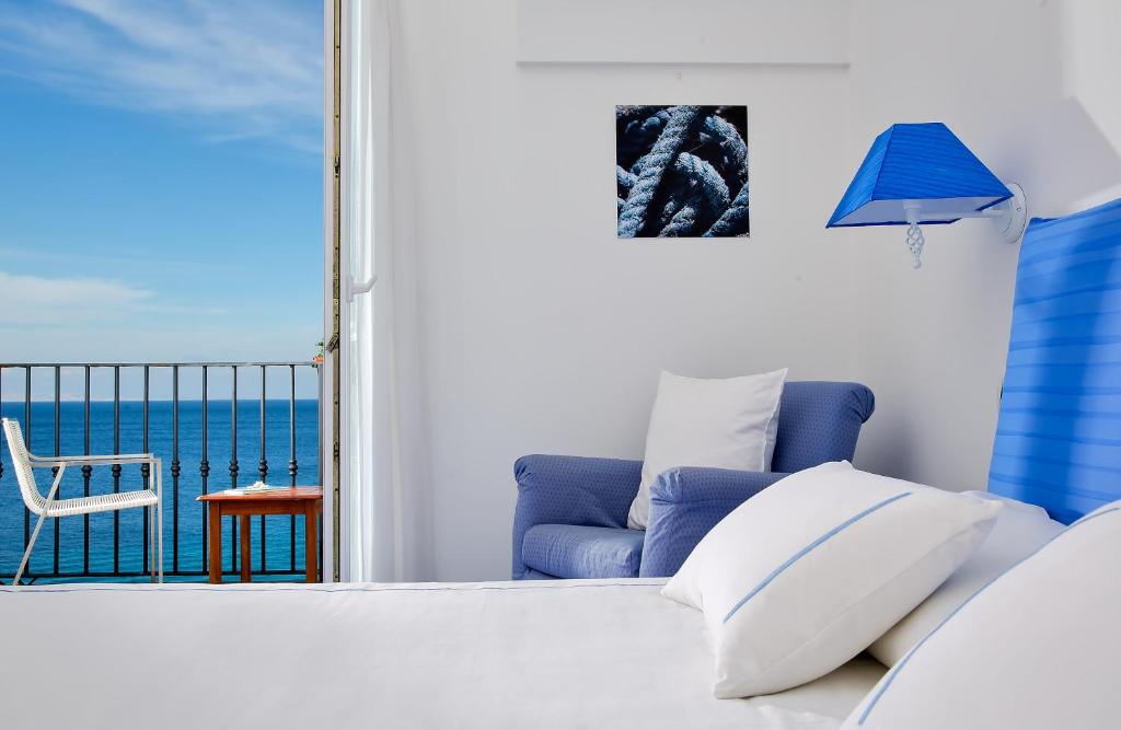 a living room with a couch and a view of the ocean at Relais Maresca Luxury Small Hotel & Terrace Restaurant in Capri