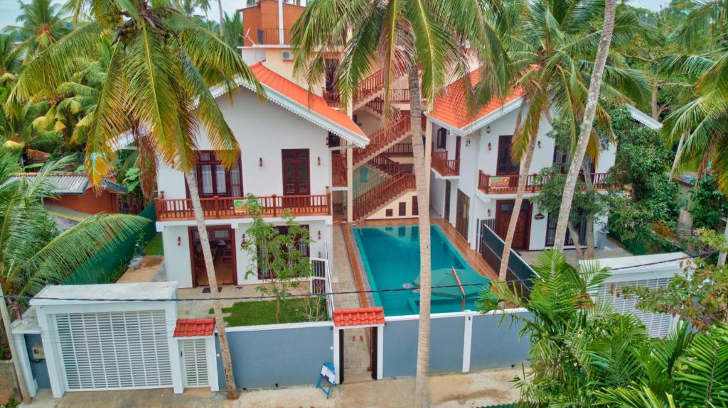 an aerial view of a house with a swimming pool at Ashiyana Hotel in Mirissa