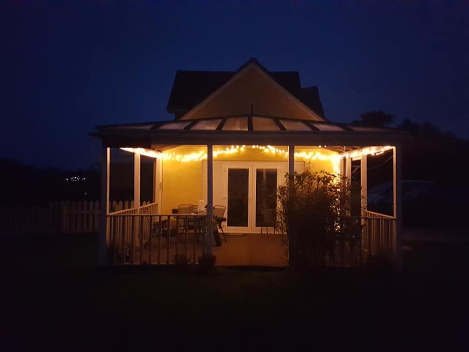 a house with lights on the front of it at night at The Station Masters Lodge in Hayle