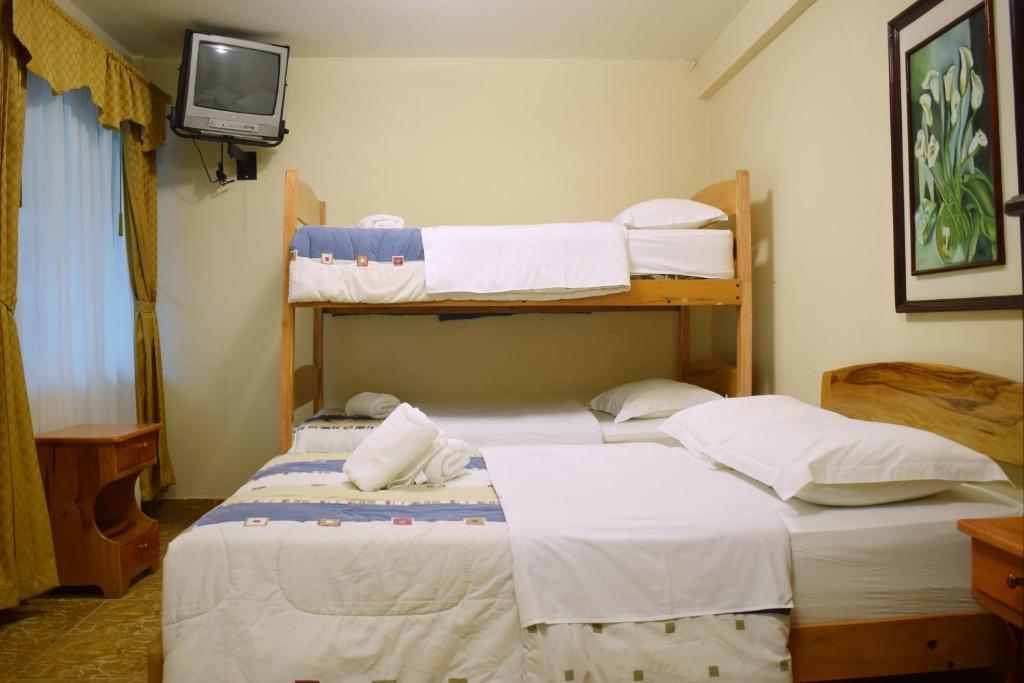 Postel nebo postele na pokoji v ubytování Meraki Hotel