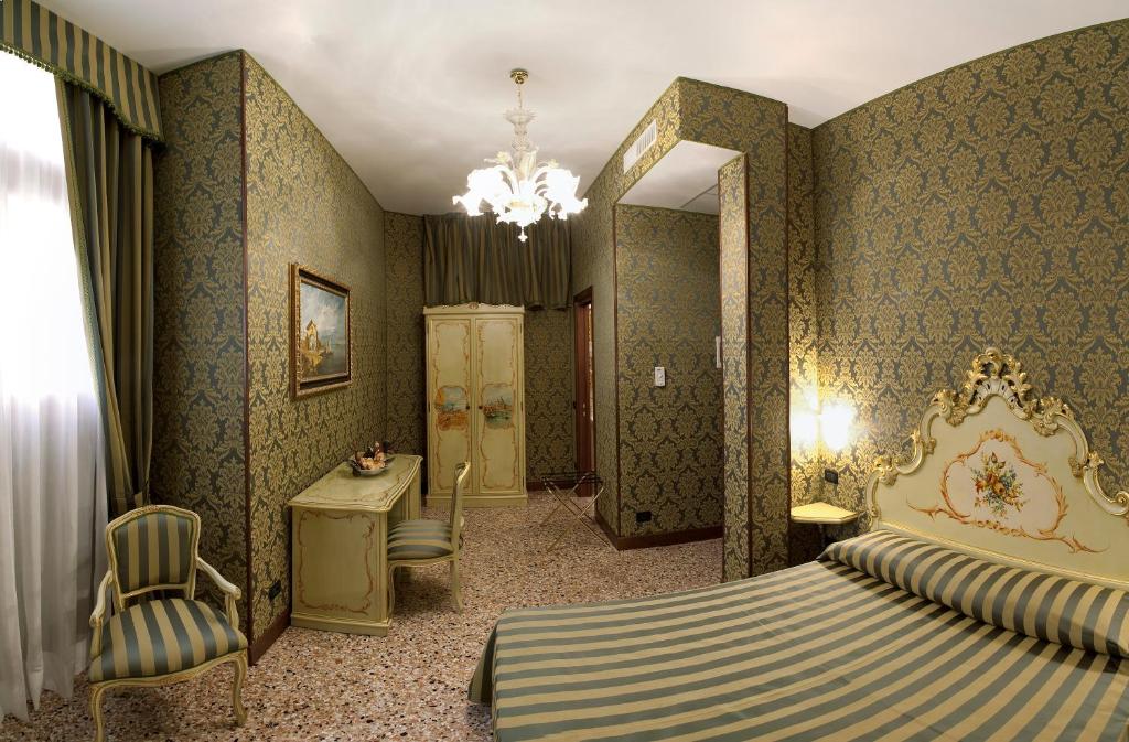 Postel nebo postele na pokoji v ubytování Hotel Al Malcanton