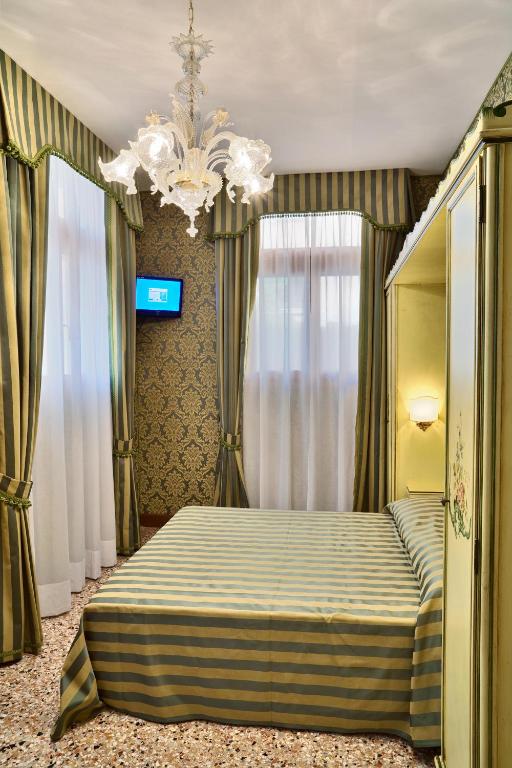 Postel nebo postele na pokoji v ubytování Hotel Al Malcanton