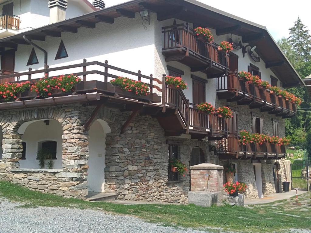 a building with flower boxes and balconies on it at Agriturismo Meizoun Blancho in Fenestrelle