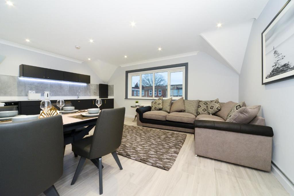 a living room with a couch and a table at Amazing Apartment near Bournemouth, Poole & Sandbanks - WiFi & Smart TV - Newly Renovated! Great Location! in Poole