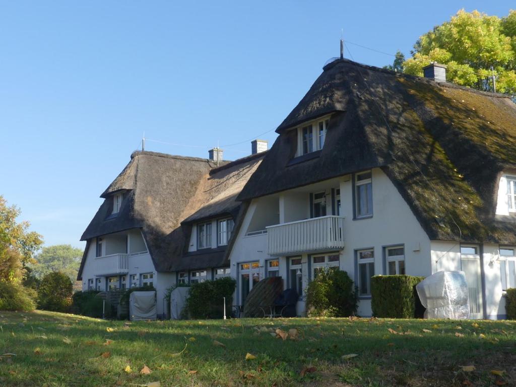 uma grande casa branca com telhado de palha em Landhaus am Haff em Stolpe auf Usedom