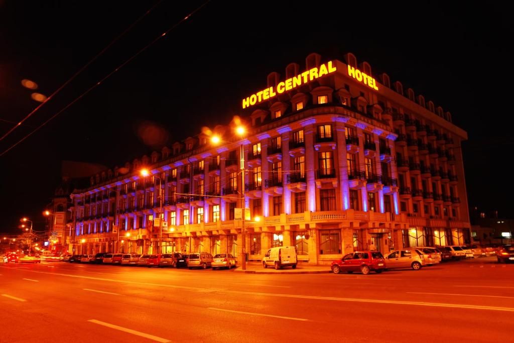 a building with purple lights on the side of it at Hotel Central in Ploieşti