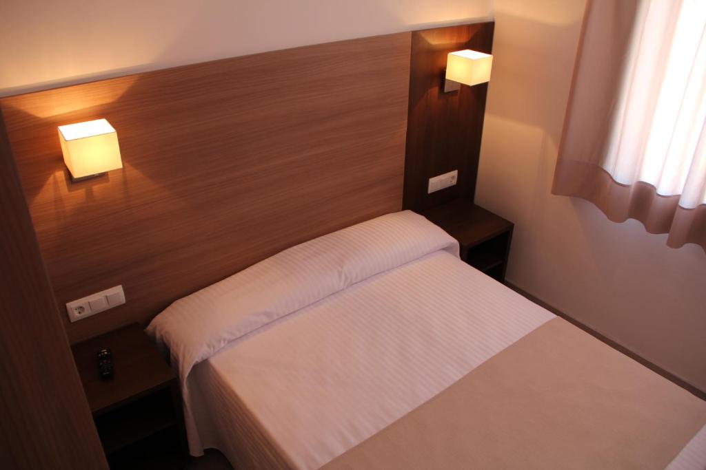 Postel nebo postele na pokoji v ubytování Hotel Victoria