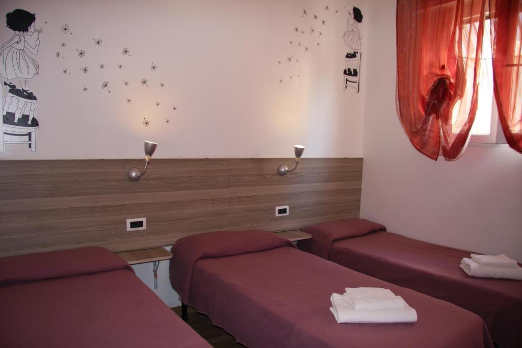 Postel nebo postele na pokoji v ubytování Hotel Adelchi
