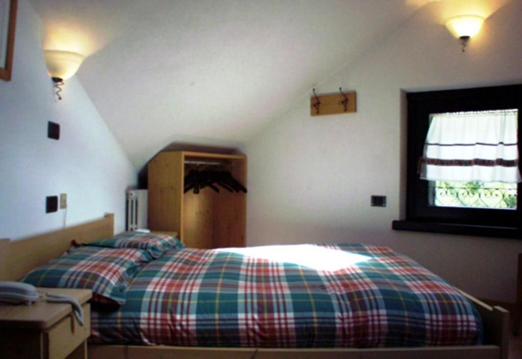 a bedroom with a bed and a window in a attic at Chalet Villa Valania in Valdidentro