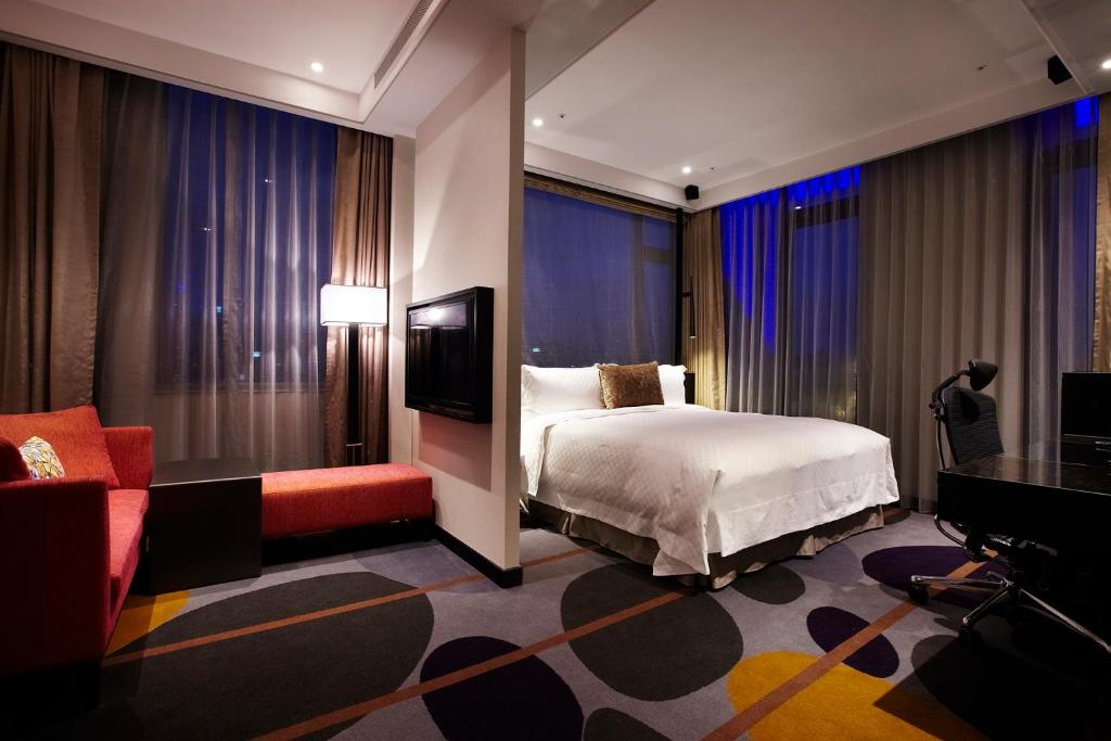 een hotelkamer met een bed en een televisie bij The Tango Hotel Taipei ChangAn in Taipei