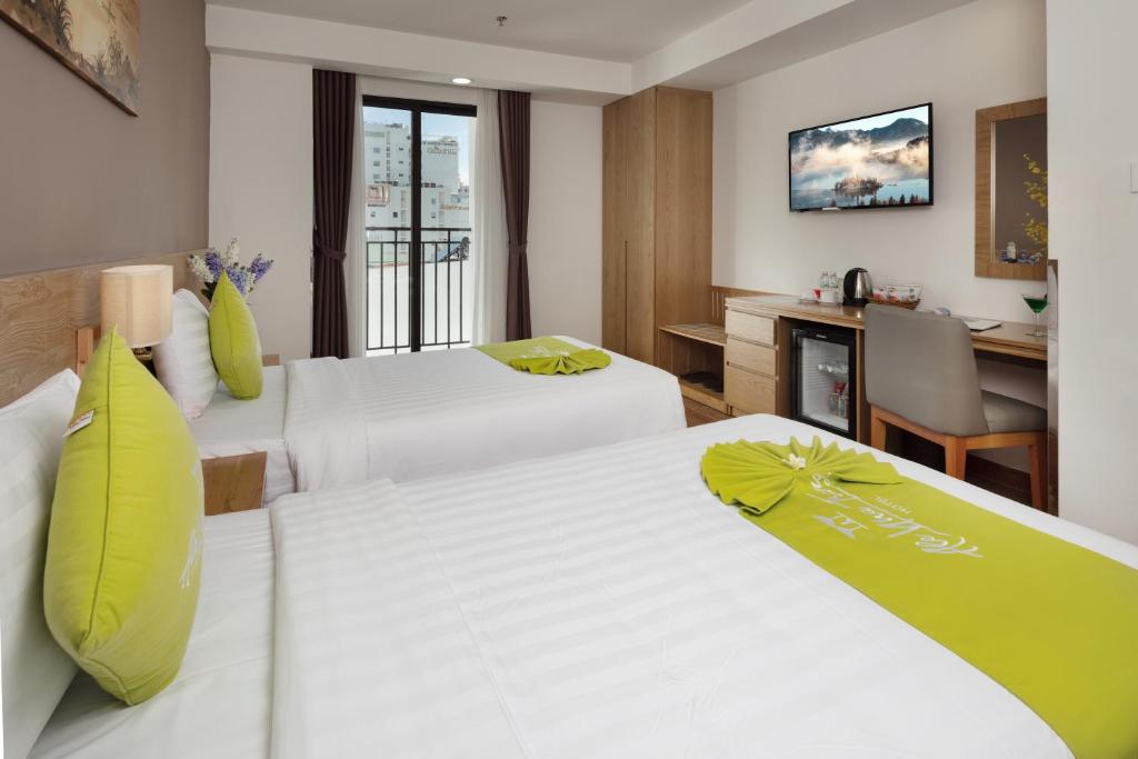 Giường trong phòng chung tại Ale Nha Trang Hotel