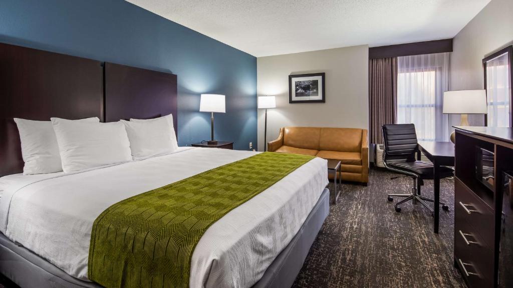 a hotel room with a large bed and a desk at Best Western Rock Hill in Rock Hill