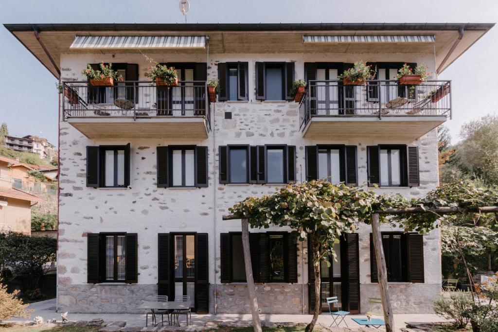 an old house with black windows and balconies at Casa Ortensia by Villa Porta Collection in Luino