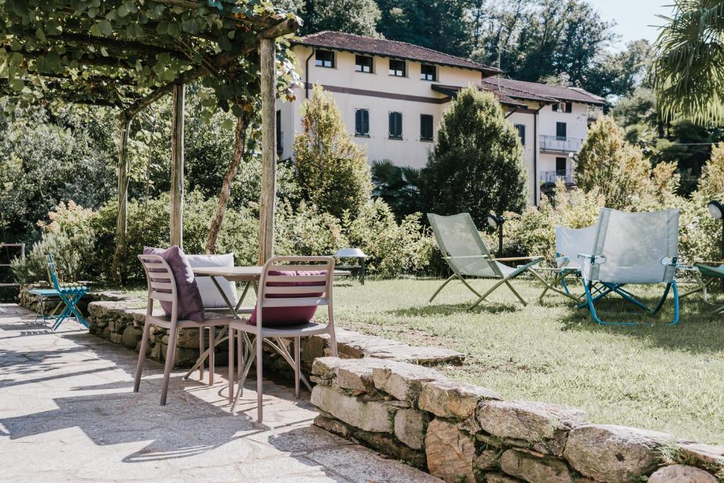 un groupe de chaises et une table dans une cour dans l'établissement Residenza Ortensia, à Luino